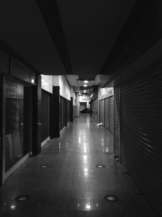 a large long hallway with the lights on