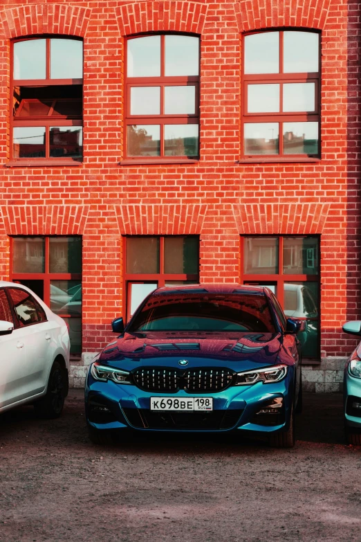 three bmws sit parked outside of a building