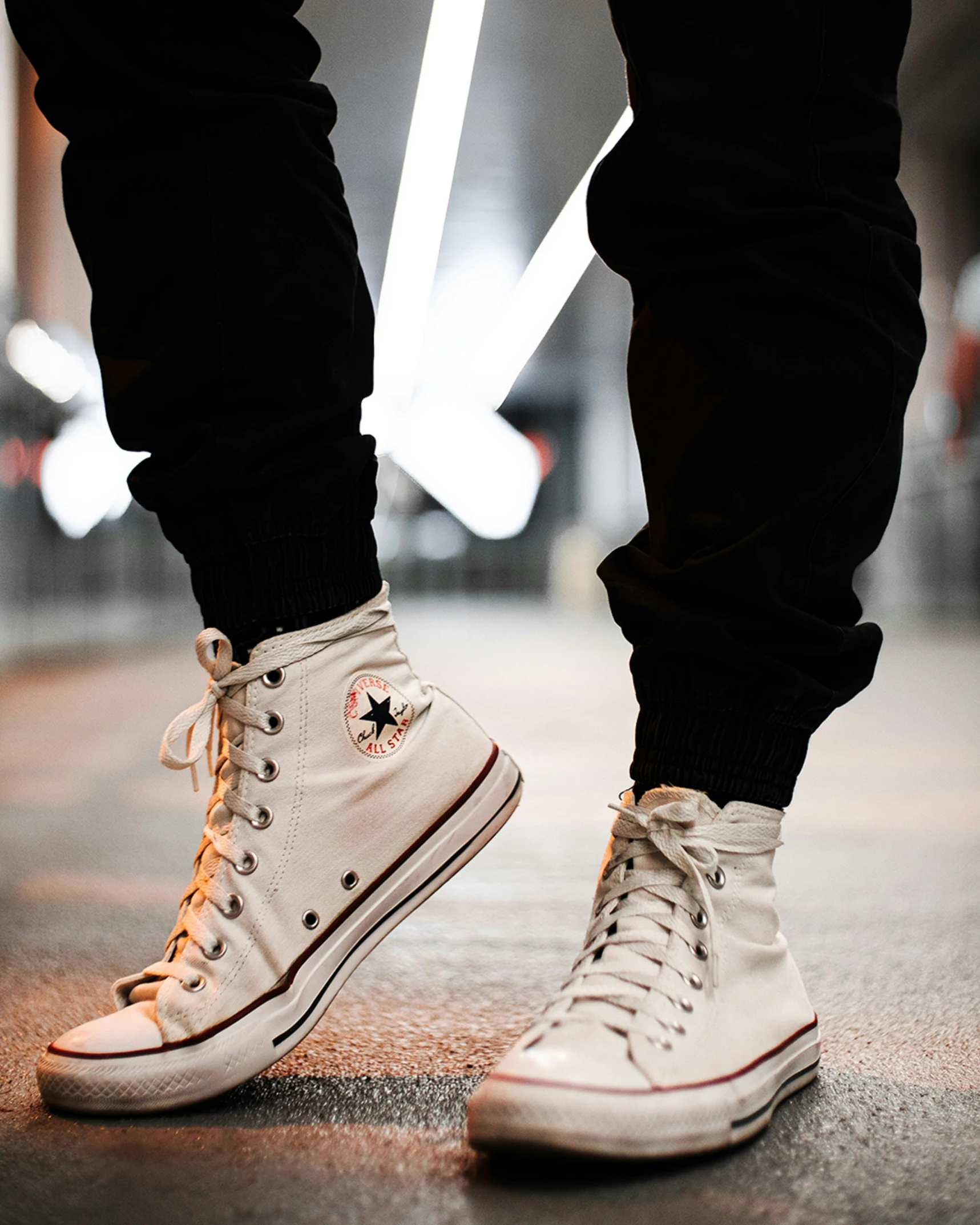 this is a close up s of a person's feet wearing converse high - top sneakers