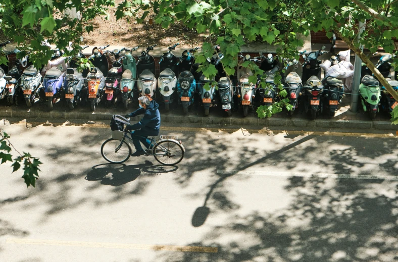 a man rides a bicycle on the street in front of people