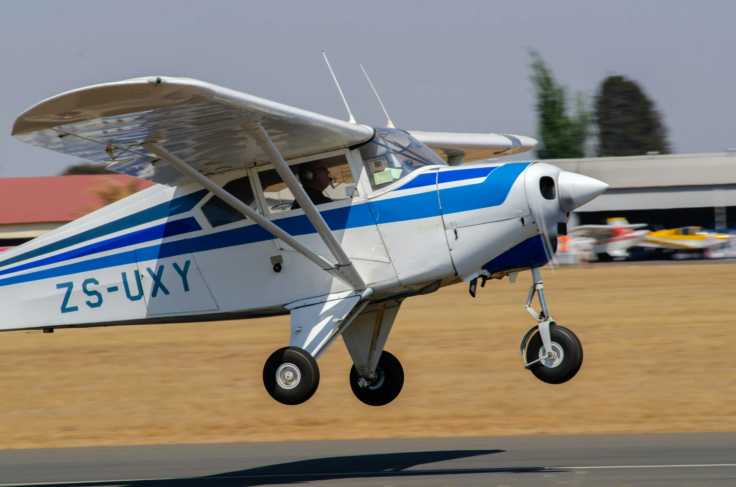 a small airplane taking off from an airport