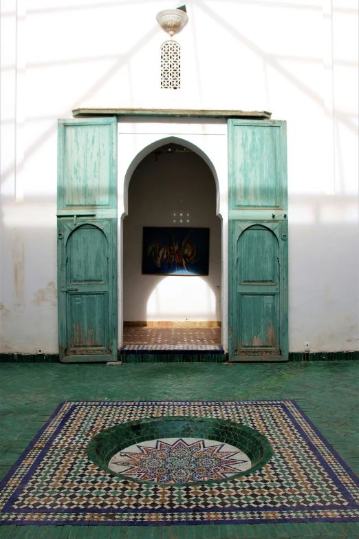 a hallway way with green doors and patterned rug