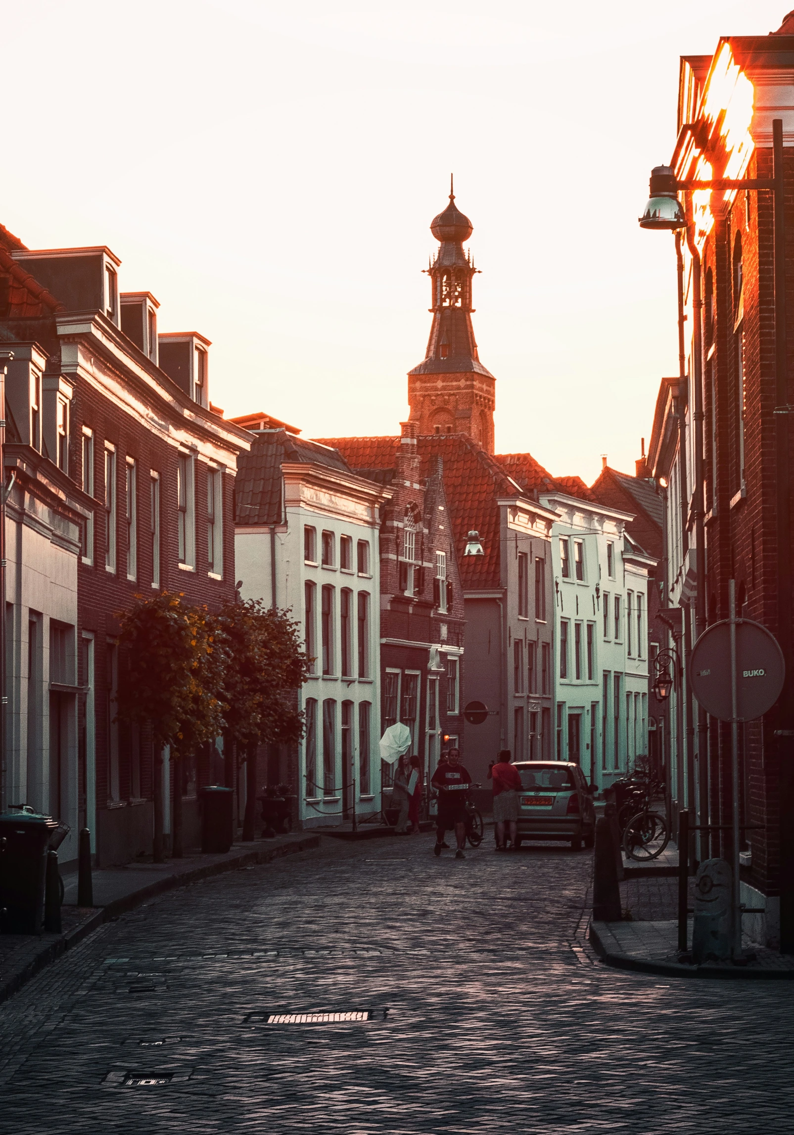 the view of old brick street lined with buildings