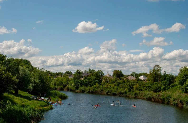 a body of water with a lot of people in boats on it