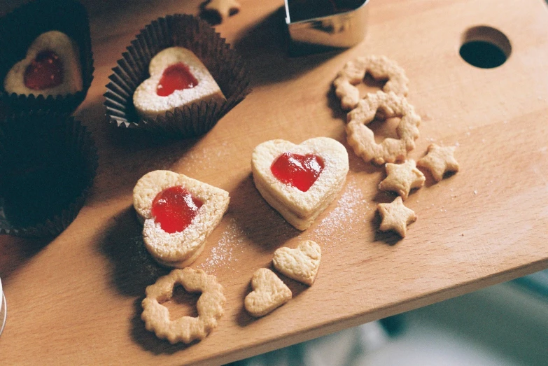 several small cookies with jelly hearts and sugar star