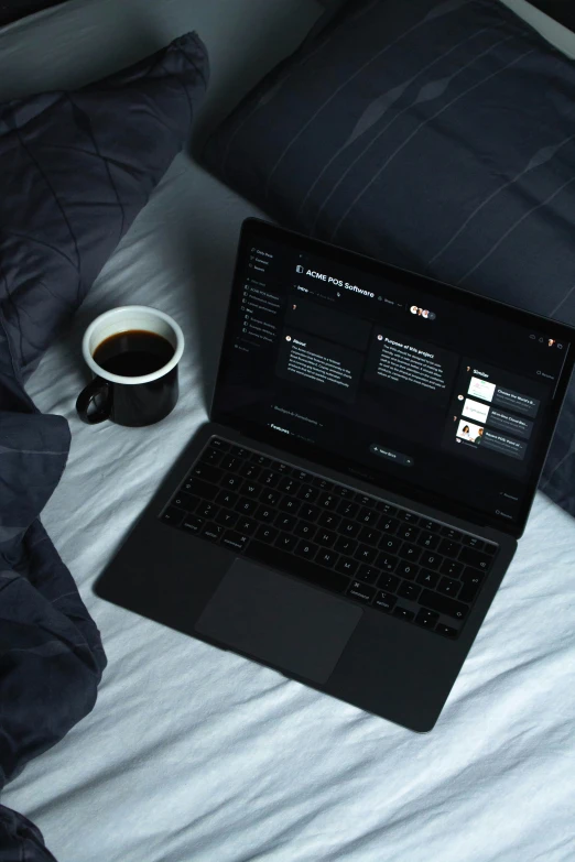 a laptop computer sitting on top of a bed