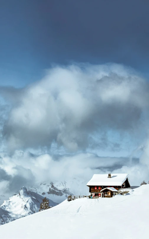 some snow a building and clouds and a mountain