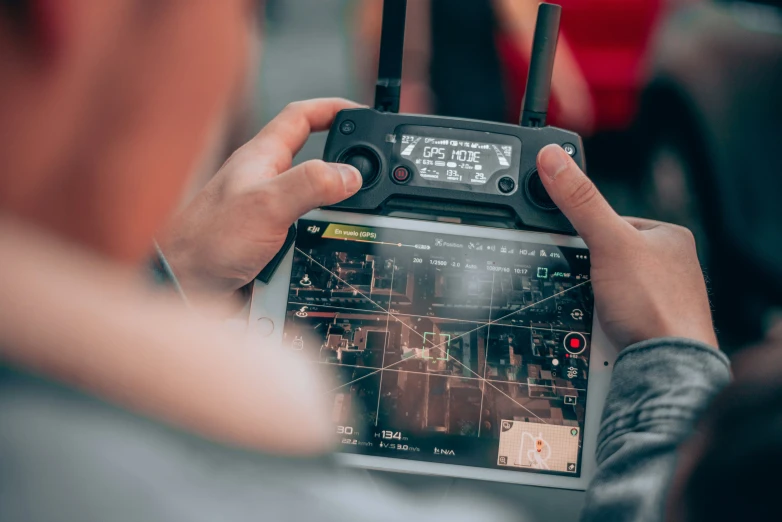 a person holds an electronic device over their hand