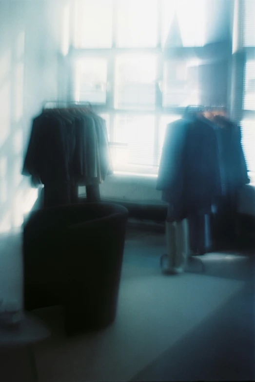 a blurry image of people standing in front of a window