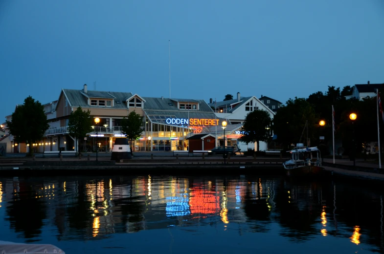 night scene of a town with the lights on and reflections in the water