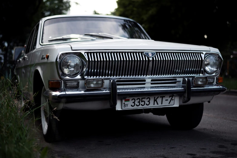 a car parked in a field beside a road