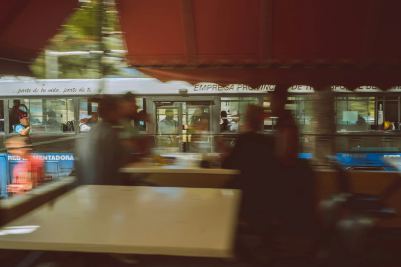 an outdoor restaurant has tables set up next to the food trucks