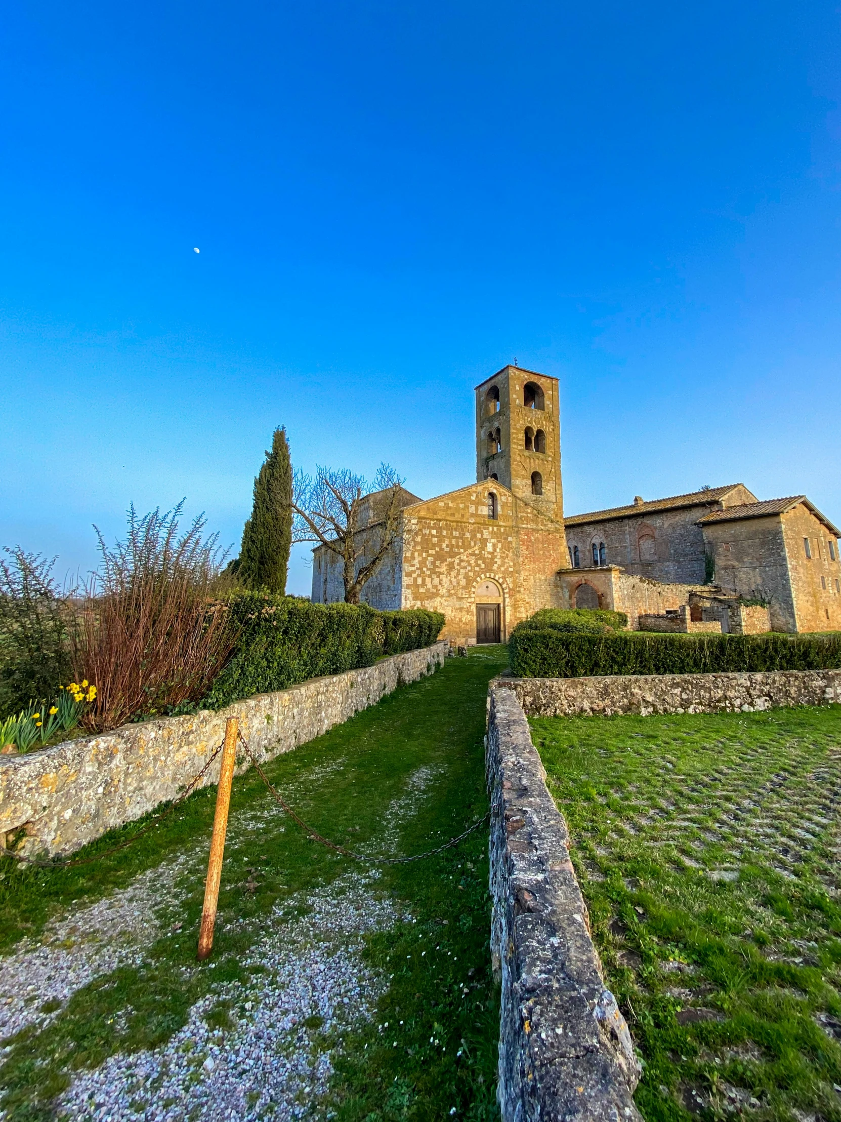 a grassy area next to an old stone building