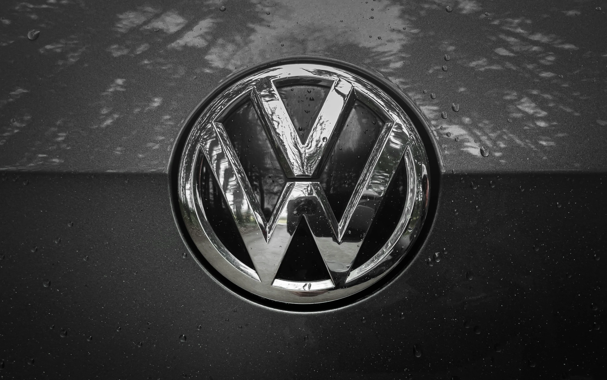 a vw badge sitting on the side of a vehicle