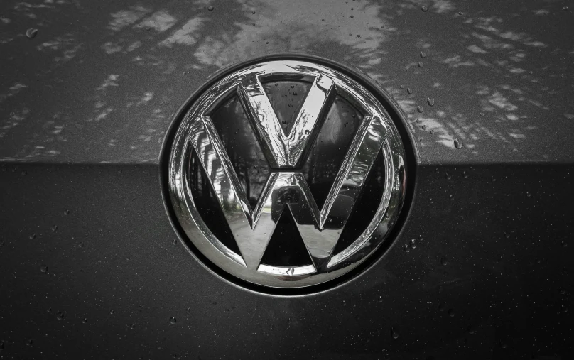 a vw badge sitting on the side of a vehicle