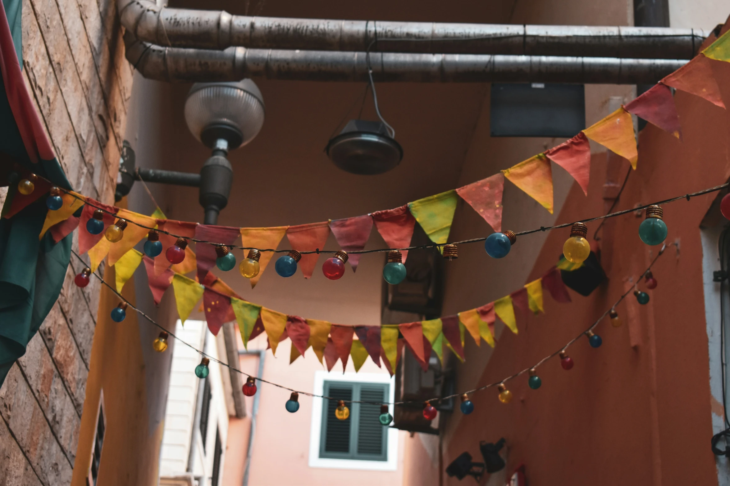 a narrow street with some colorful lights on it