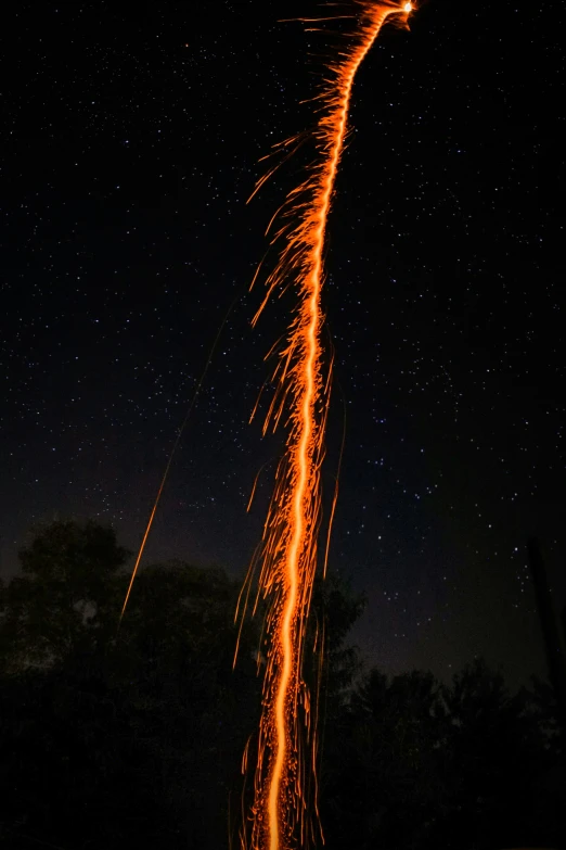a firework exploding at night while glowing