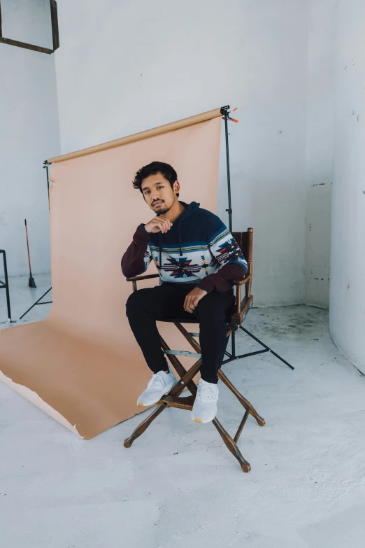 a man sitting on top of a chair next to a po