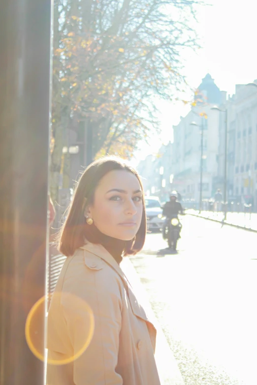 a woman standing on the side of a road with her head down