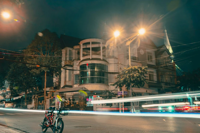 a street scene at night with traffic lights and light streaks