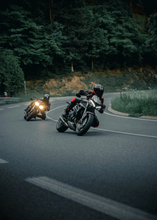 two motorcycles on the street in front of a motorcycle