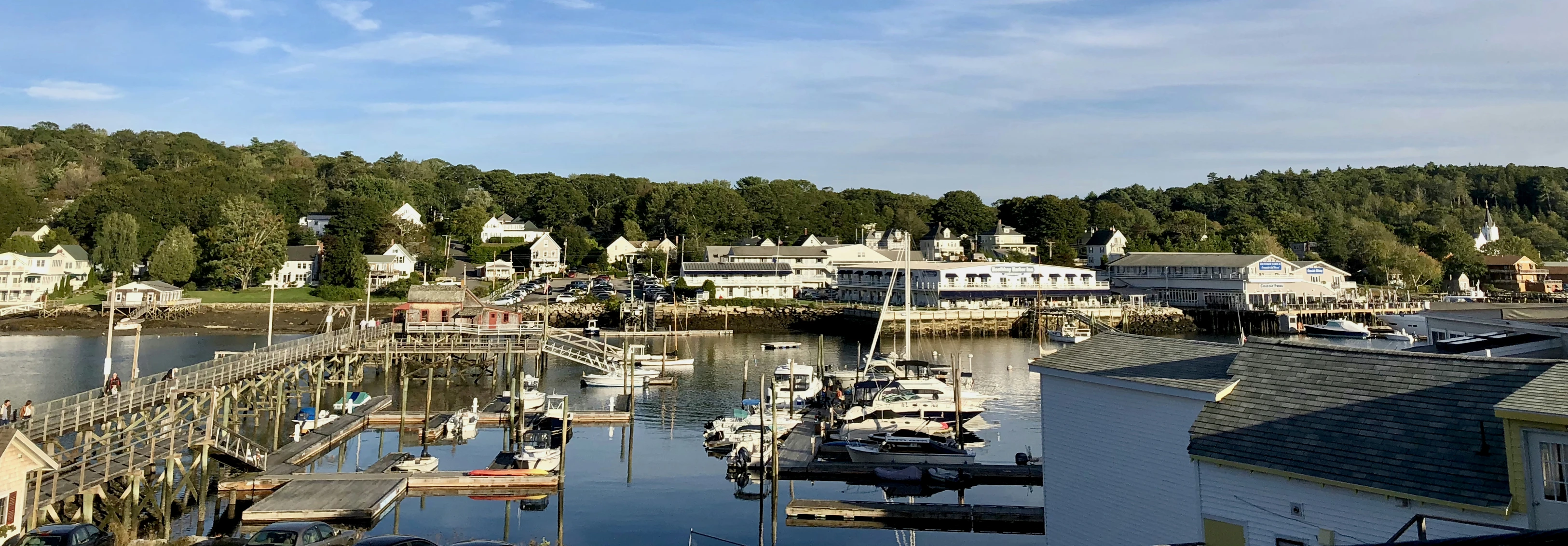 boats docked at a marina in front of a white building