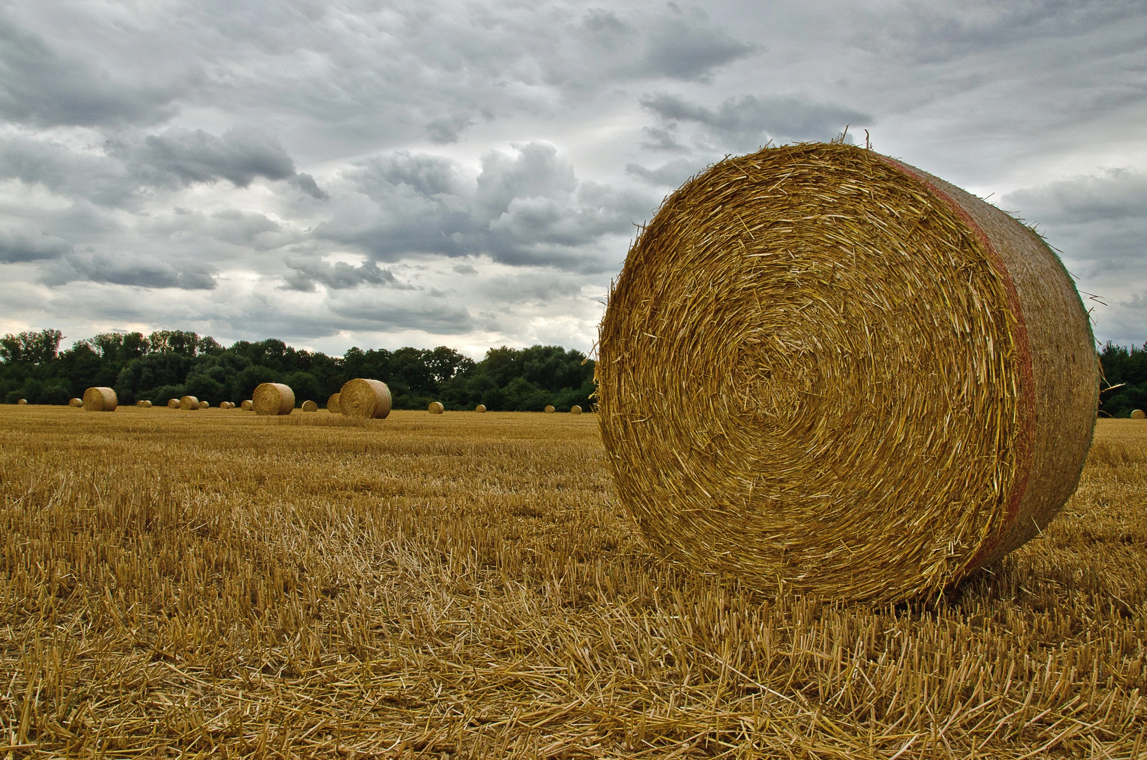 hay bails sitting on the side of a road