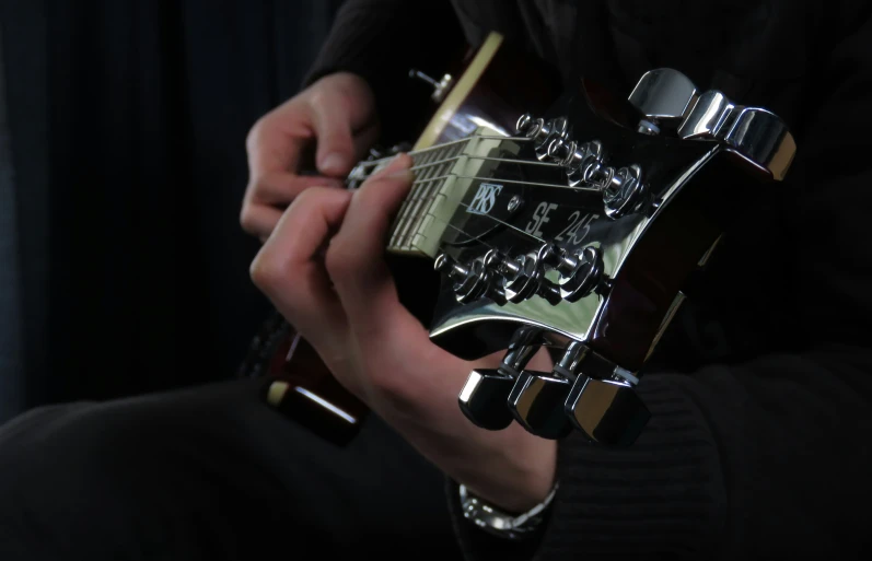 the head of a man playing an electric guitar