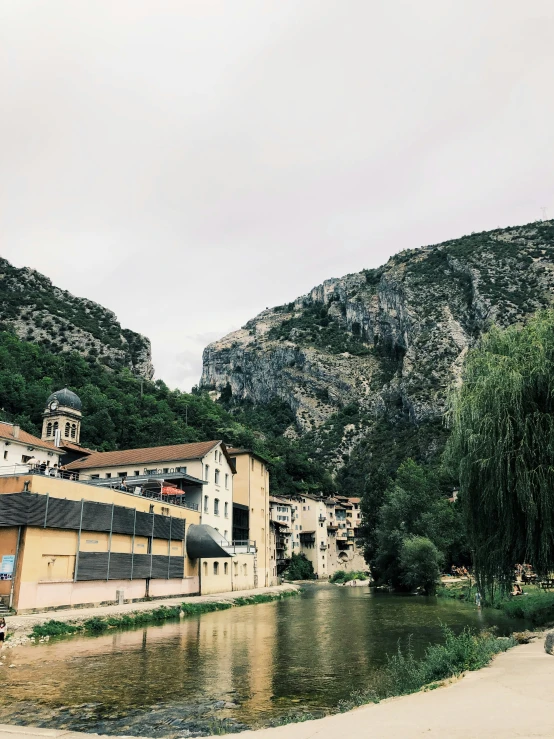 a river with some buildings and trees by it