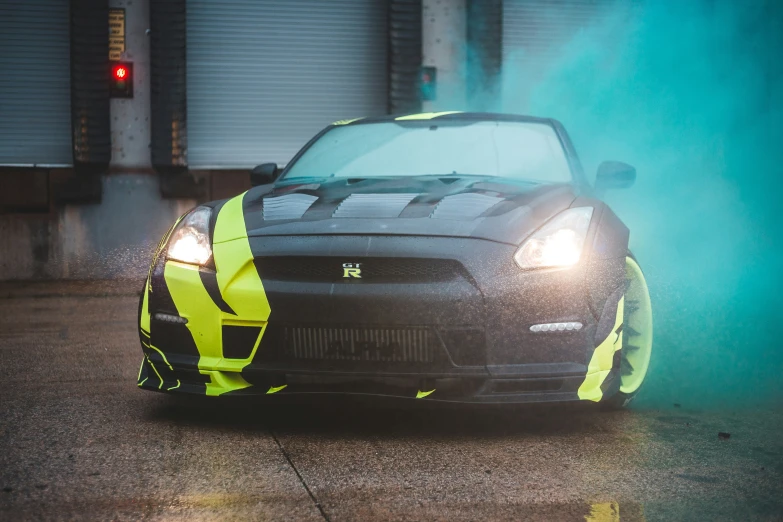 an automobile on the street at night with smoke behind it