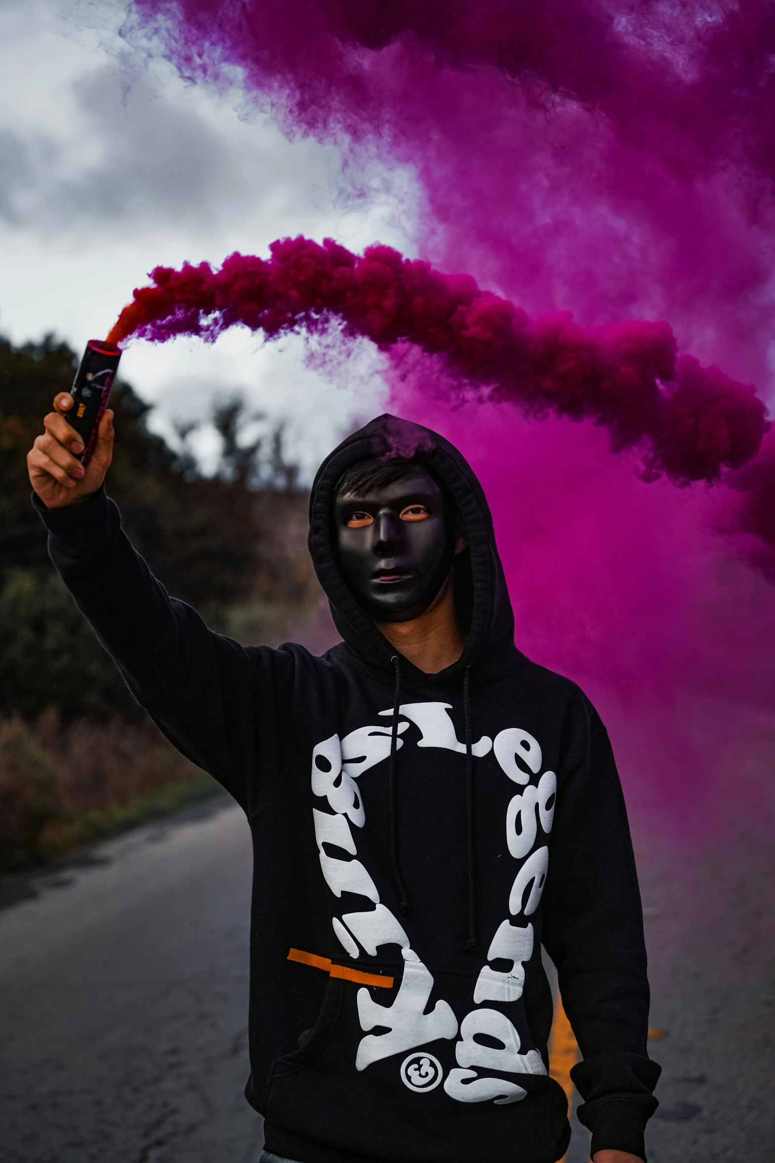 a young man is holding a smoking device