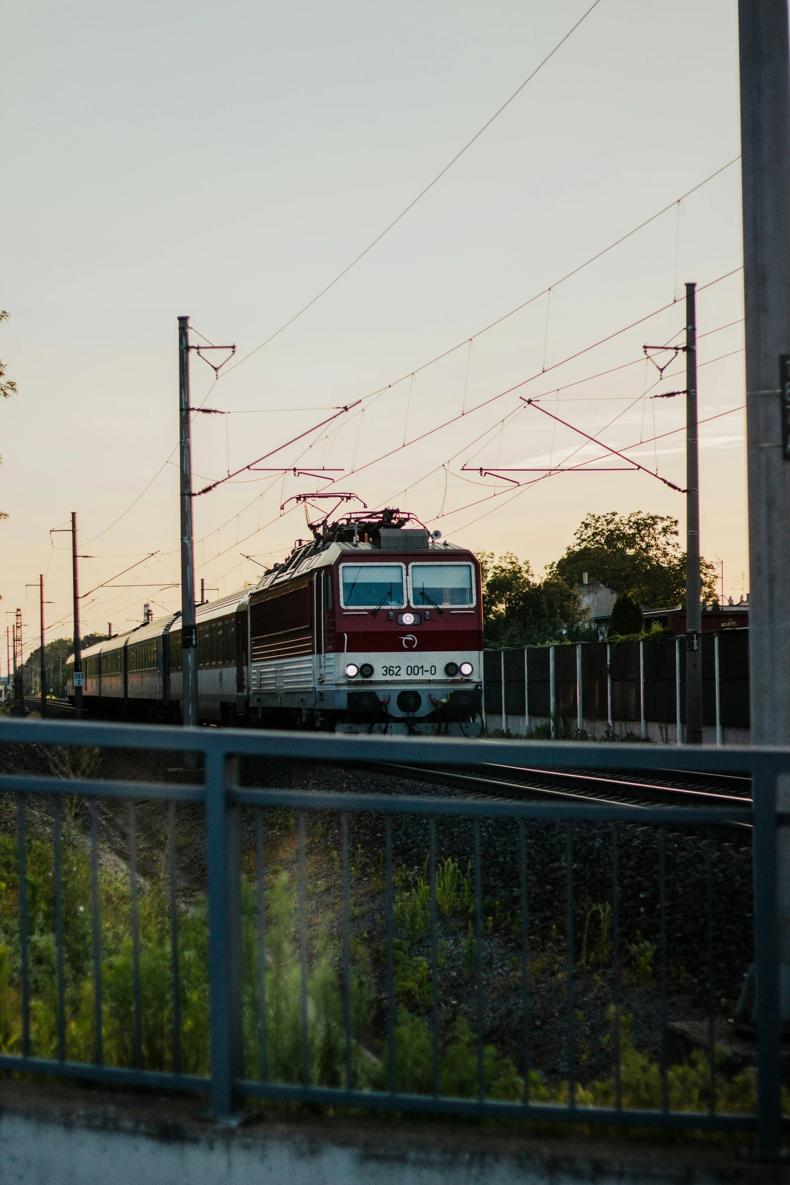 an empty train on the train tracks during the sunset