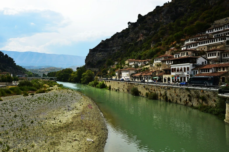 a river flowing between two large cliff side towns