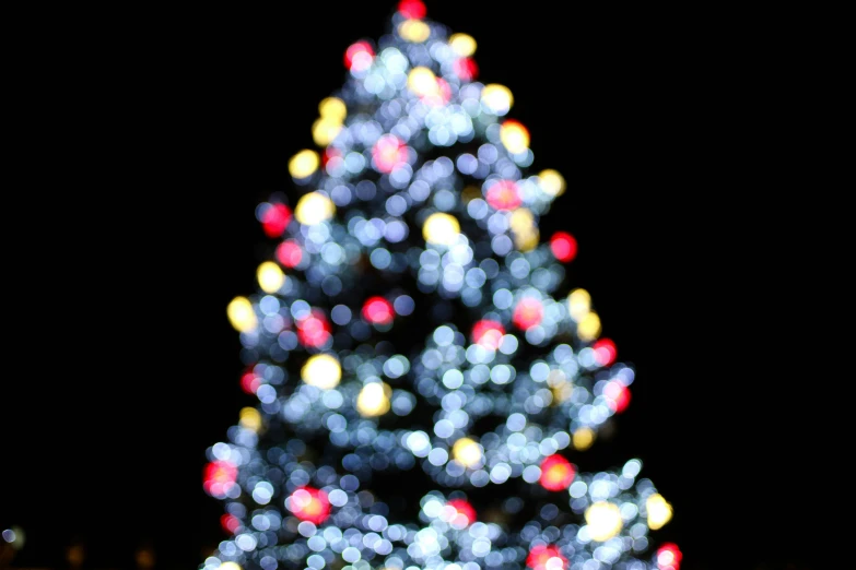 a very beautiful bright christmas tree decorated with lights