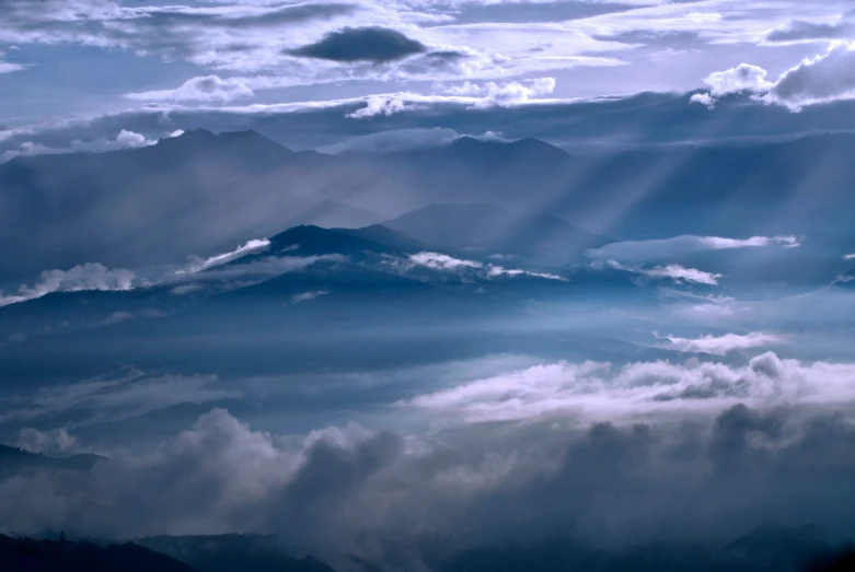 sunlight shining down on the top of mountain tops