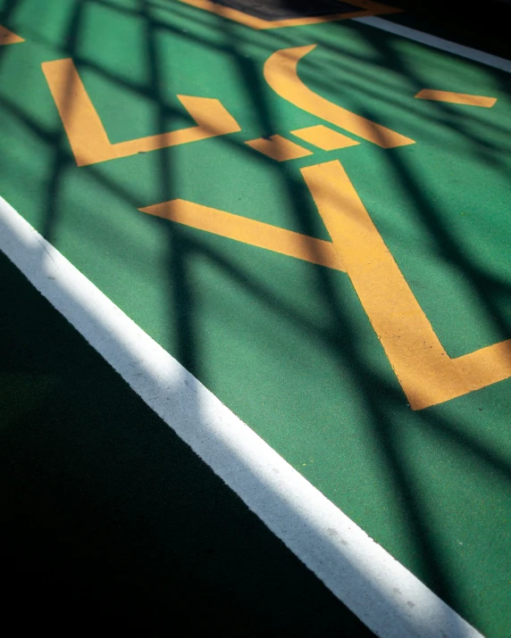 a green and white bicycle lane with an arrow painted on it