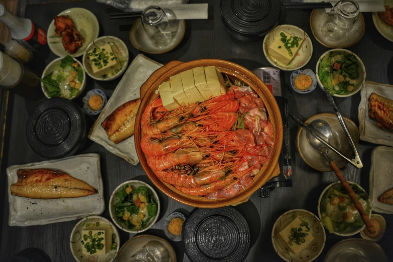 an assortment of various foods on plates, near a wooden table