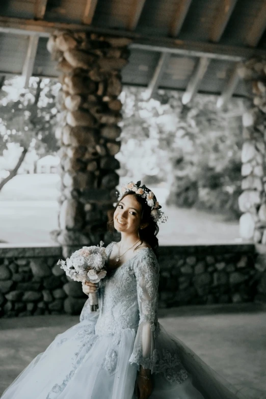 a woman in an elegant wedding dress holds a bouquet