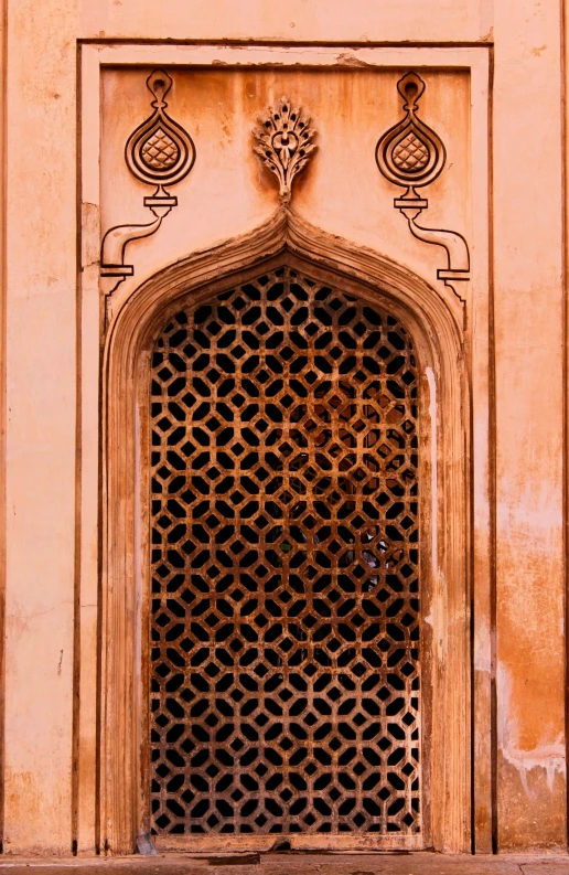 a metal grille with a bird design in it