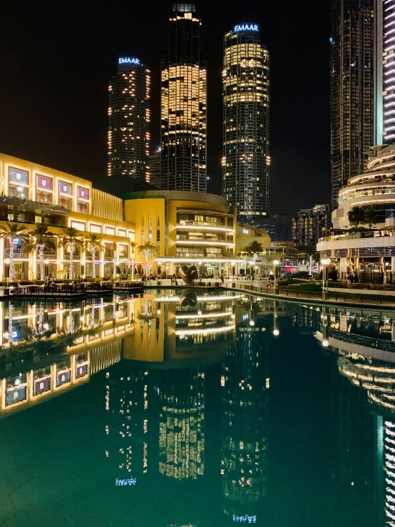 a pool in a city center with bright lights on it