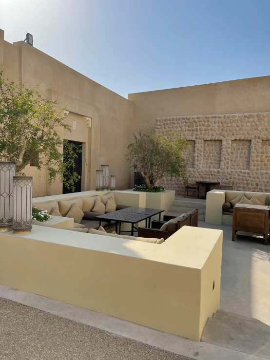 outdoor seating on patio next to building with potted plant