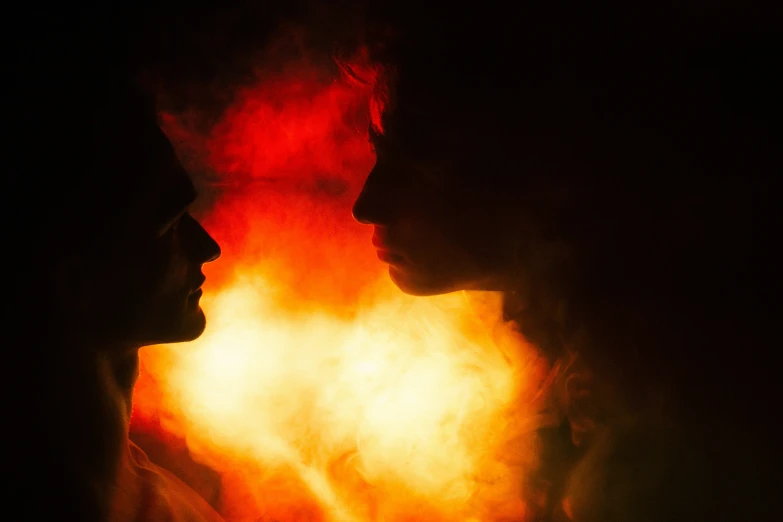 two silhouettes of men standing in front of the light colored background