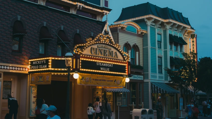 the entrance to the wizard theatre on a street corner at night