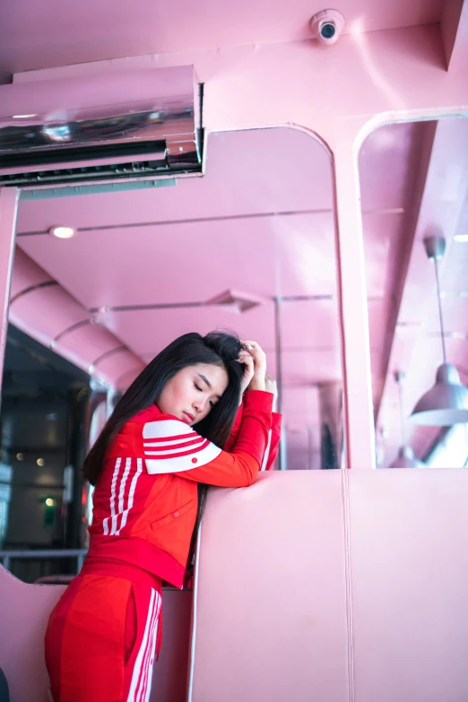 an image of a woman in a red tracksuit