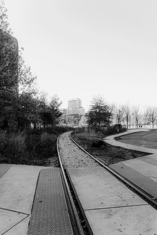 black and white pograph of railroad tracks and a building