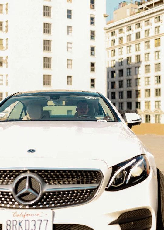 a white car driving down the road