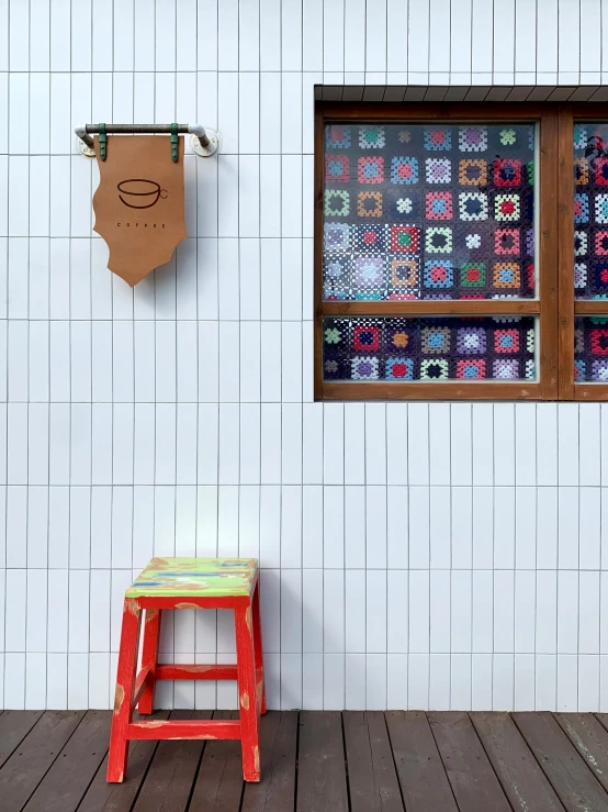 a colorful chair sits next to a wooden table