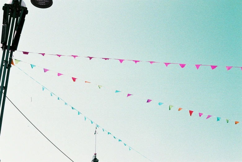 colorful flags on top of a street light