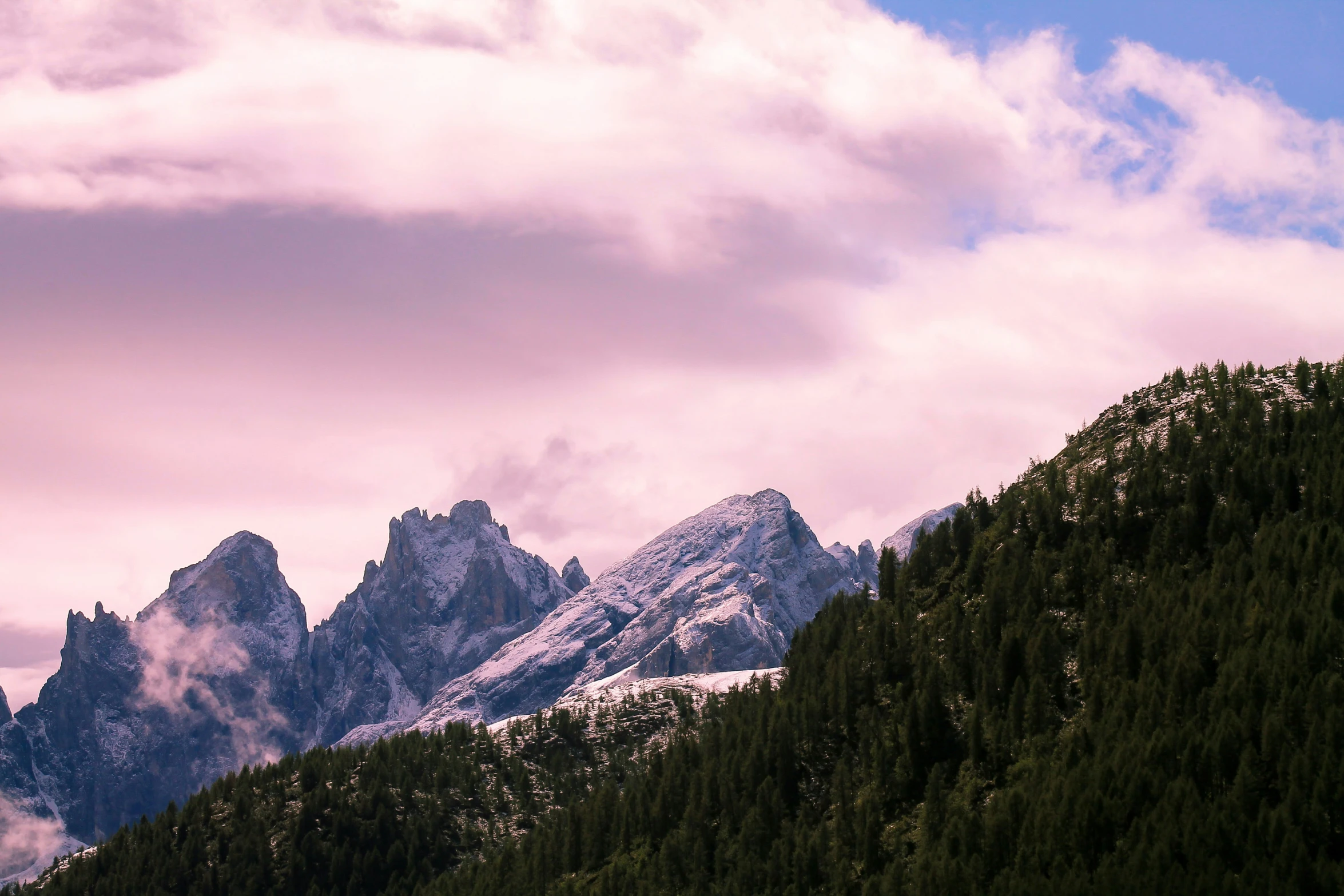 the high mountains rise above the forest to get to the cloud