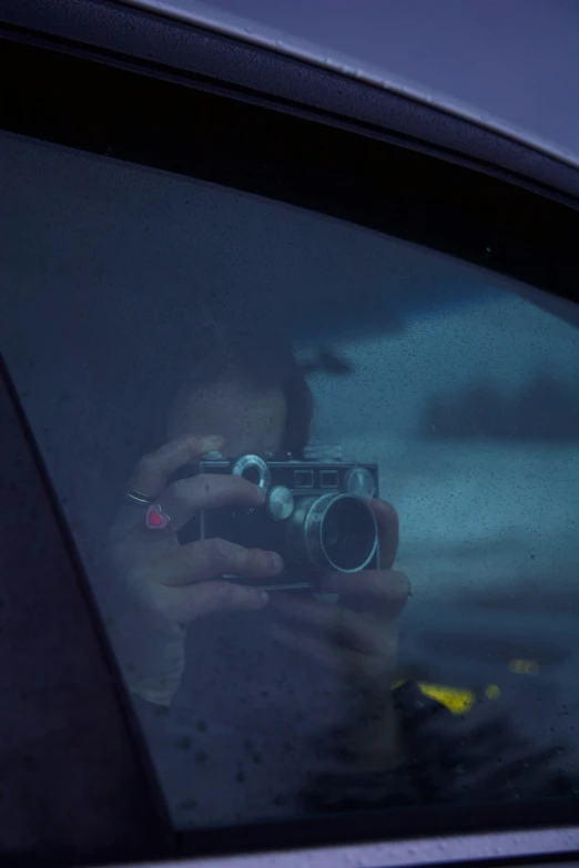 a woman taking a picture of herself in a mirror